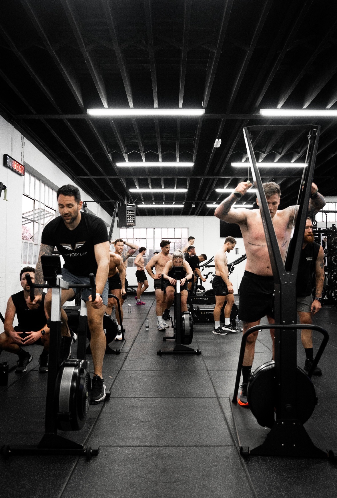 The Physical Formula floor mid-session, members on the ergs and ski